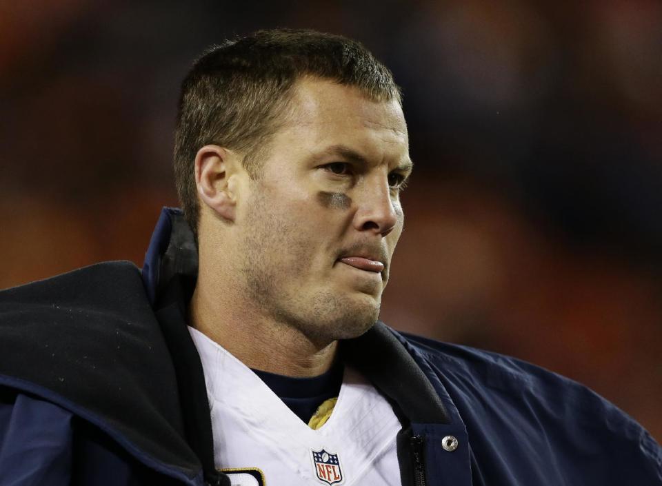 San Diego Chargers quarterback Philip Rivers watches from the sidelines against the Denver Broncos in the fourth quarter of an NFL AFC division playoff football game, Sunday, Jan. 12, 2014, in Denver. Denver won 24-17. (AP Photo/Charlie Riedel)