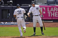 New York Yankees' DJ LeMahieu, right, greets Aaron Hicks, left, after he scored on a sacrifice fly hit by Brett Gardner during the second inning of a baseball game against the Detroit Tigers at Yankee Stadium, Sunday, May 2, 2021, in New York. (AP Photo/Seth Wenig)