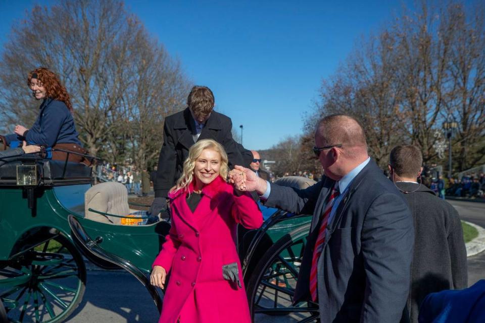 Kentucky First Lady Britainy Beshear is helped out of a carriage during the inaugural parade in Frankfort, Ky., on Tuesday, Dec. 12, 2023.