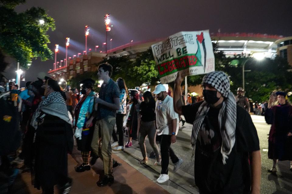 Pro-Palestinian protesters march after UT's commencement ceremony Saturday at Royal-Memorial Stadium.