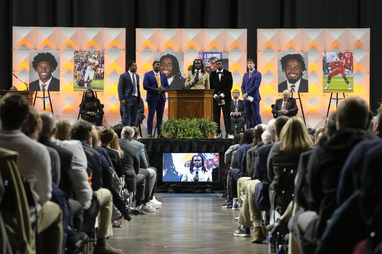 A University of Virginia football player speaks during a memorial service for three slain University of Virginia football players Lavel Davis Jr., D'Sean Perry and Devin Chandler at John Paul Jones Arena at the school in Charlottesville, Va., Saturday, Nov. 19, 2022. (AP Photo/Steve Helber, Pool)