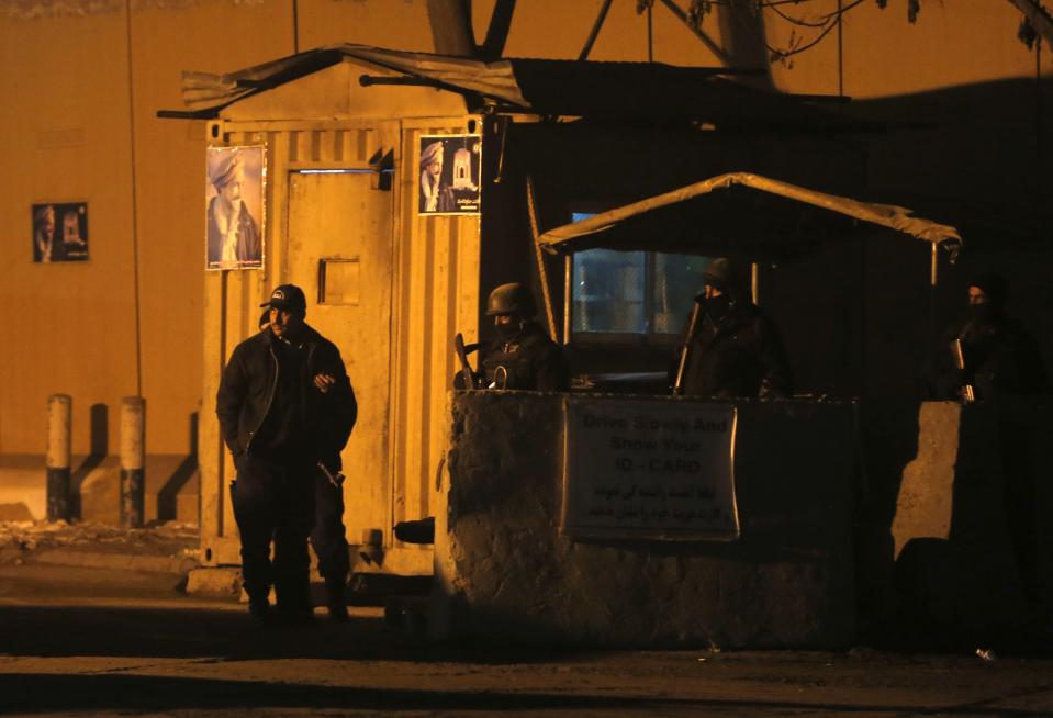 Afghan security personnel keep watch near the site of an explosion at Camp Eggers in Kabul