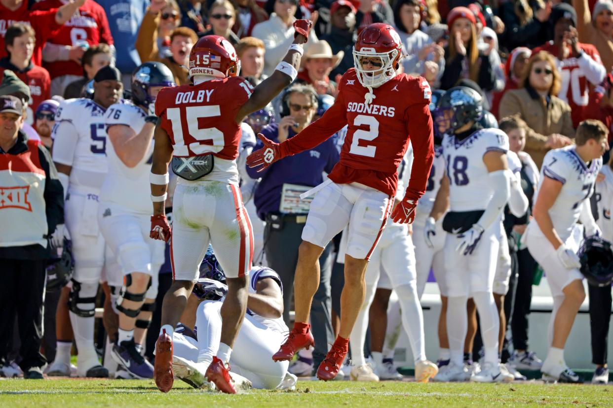 Oklahoma Sooners defensive back Billy Bowman Jr. (2) and defensive back Kendel Dolby (15) celebrate during a college football game between the University of Oklahoma Sooners (OU) and the TCU Horned Frogs at Gaylord Family-Oklahoma Memorial Stadium in Norman, Okla., Friday, Nov. 24, 2023. Oklahoma won 69-45.