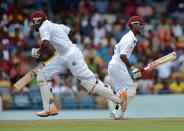 West Indies cricketers Kirk Edwards and Kraigg Brathwaite (R) take a run during the first day of the first-of-three Test matches between Australia and West Indies at the Kensington Oval stadium in Bridgetown on April 7, 2012. West Indies have scored 60/1 at lunch. AFP PHOTO/Jewel Samad (Photo credit should read JEWEL SAMAD/AFP/Getty Images)
