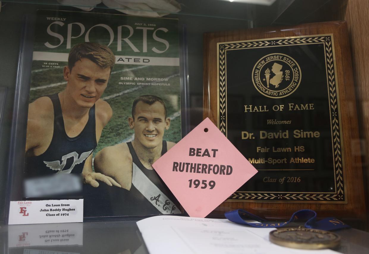 Fair-Lawn, NJ -- February 2, 2024 -- A July 1956 cover from Weekly Sports Illustrated features Dave Sime, left when he ran track for Duke University.
The trophy case and Hall of Fame Wall at Fair-Lawn HS honors one of their alumni, Dave Sime. He was a star athlete at Fair-Lawn in the 1950s, passing away in 2016. He was the grandfather of San Francisco 49ers star running back Christian McCaffrey, who will be playing in the Super Bowl.