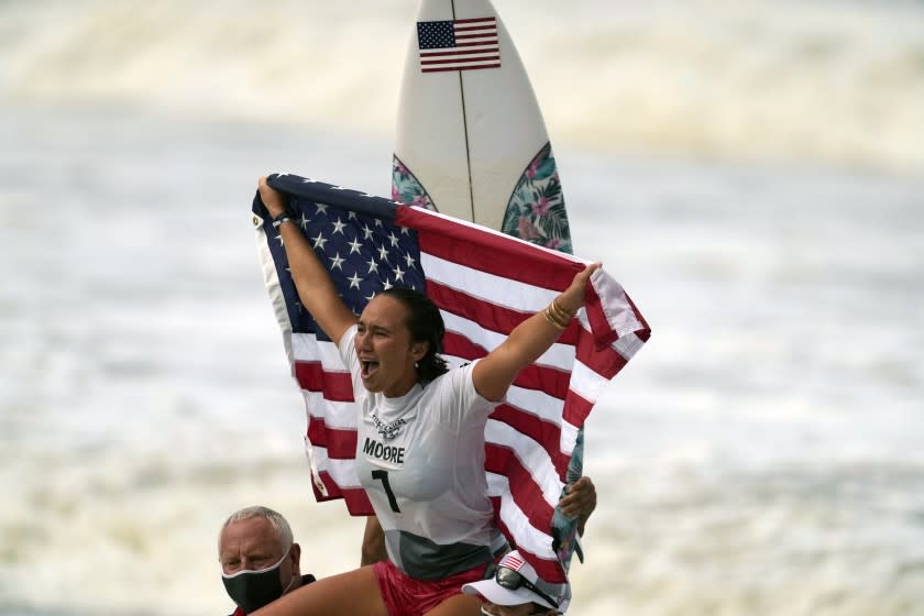 Carissa Moore, of the United States, celebrates winning the gold medal.