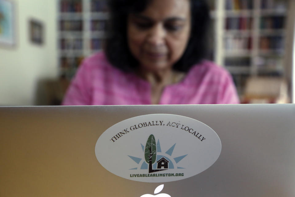 Ranjana Bhandari, executive director of Liveable Arlington, works on a laptop at her home in Arlington, Texas, on Tuesday, Oct. 26, 2021. More than a decade ago, Bhandari and her neighbors convinced an oil and gas company to locate a natural gas drill site farther away from their homes. Now she is helping residents in other Arlington neighborhoods, particularly those with fewer resources, to do the same. She has taken particular aim at TEP Barnett, a subsidiary of French energy giant Total Energies, which has 33 well sites in Arlington and more in neighboring communities. (AP Photo/Martha Irvine)