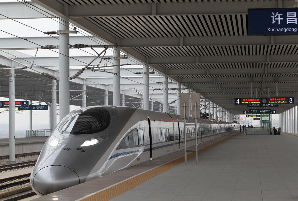 The high speed train that runs on the new 2,298-kilometre (1,425-mile) line between Beijing and Guangzhou stops at Xuchang East Station in Xuchang, central China's Henan province on December 26, 2012. China started service on December 26 on the world's longest high-speed rail route, the latest milestone in the country's rapid and -- sometimes troubled -- super fast rail network. The opening of this new line means passengers will be whisked from the capital to the southern commercial hub in just eight hours, compared with the 22 hours previously required. CHINA OUT AFP PHOTO