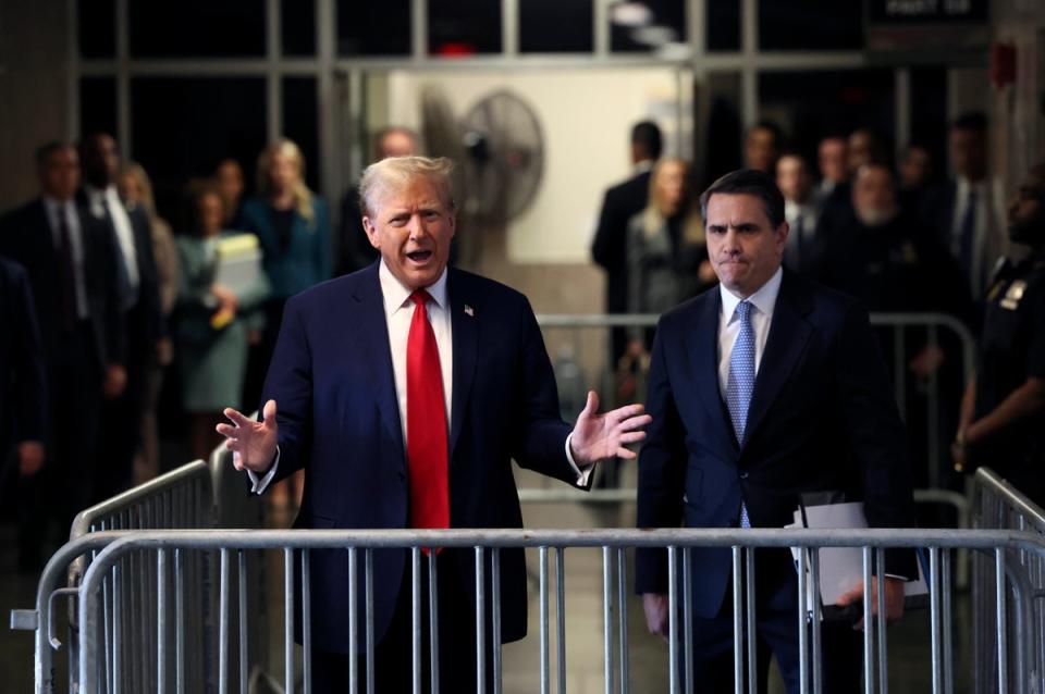 Former US President Donald Trump speaks to the media as he arrives at Manhattan criminal court for his hush money trial on 23 April 2024 (Getty Images)