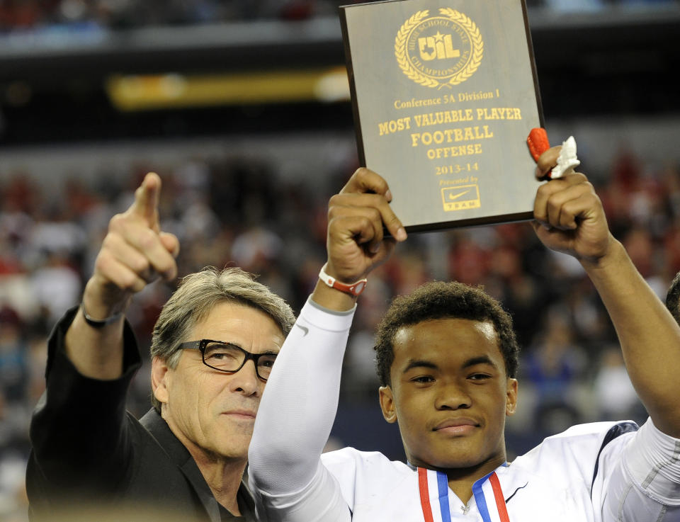 FILE - In this Dec. 21, 2013 file photo, Texas Gov. Rick Perry, left, poses for photos with the most valuable player,  offensive, Allen quarterback Kyler Murray, following a 63-28 win over Pearland during a UIL Class 5A  Division I high school football championship game in Arlington, Texas. Murray, who has a 41-0 record as the starter and is trying to win a third straight state championship, is the Texas Associated Press Sports Editors Player of the Year.  (AP Photo/Matt Strasen, File)