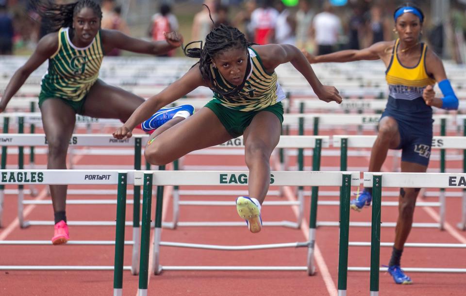 George Jenkins' Chelsi Williams jumps over the last hurdle in the 100 hurdles on Thursday at the Class 4A, District 6 track and field meet at George Jenkins High School.