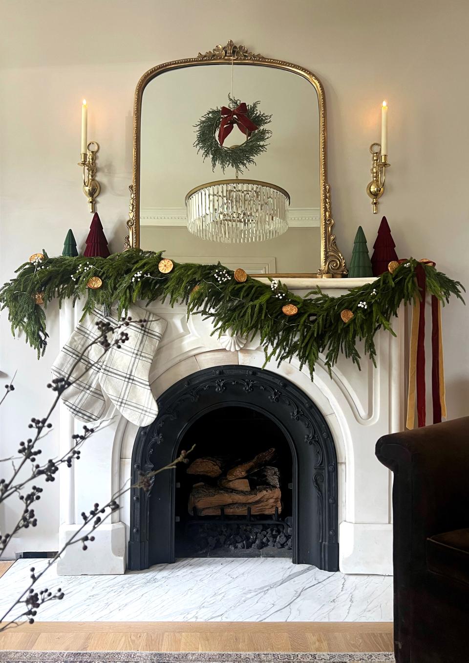 An antique Victorian marble fireplace mantel sourced by Mantel House LLC and decorated for Christmas.