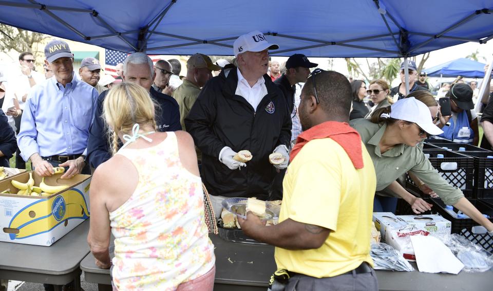 <p>President Donald Trump (C), with Florida Governor Rick Scott (L), US Vice President Mike Pence (2nd L) and First Lady Melania Trump (R), helps serve food to people affected by Hurricane Irma, in Naples, Florida, on September 14, 2017. (Photo: Brendan Smialowski/AFP/Getty Images) </p>