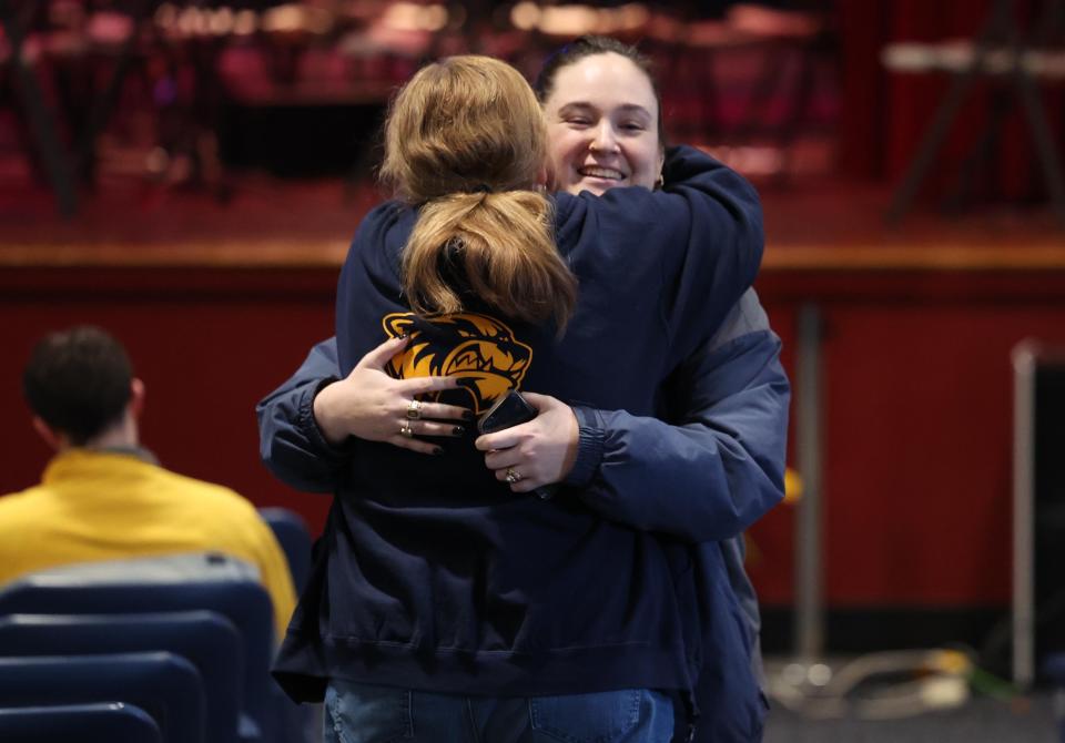Brockton High School first-year teacher Allison Russell, right, is comforted after speaking at a meeting at West Middle School in Brockton with state legislators about severe student behavior problems on Thursday, Feb. 15, 2024.