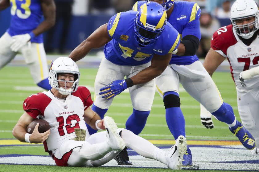 Los Angeles, CA - November 13: Arizona Cardinals quarterback Colt McCoy (12) falls to the ground after being sacked in front of Los Angeles Rams linebacker Bobby Wagner (45) during the first half at SoFi Stadium on Sunday, Nov. 13, 2022 in Los Angeles, CA. (Allen J. Schaben / Los Angeles Times)