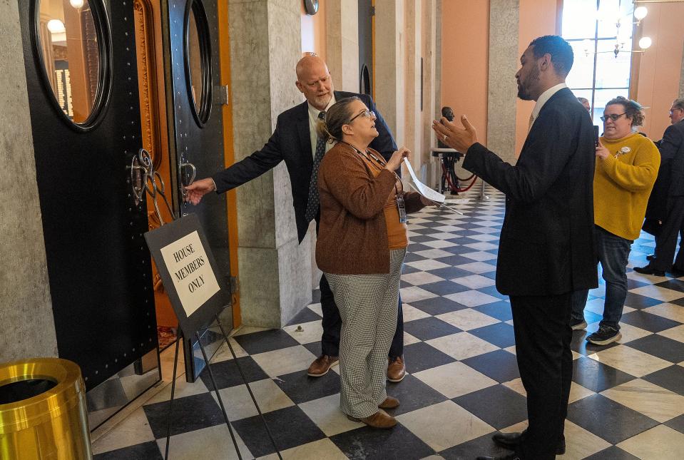 Jeanne Ogden with Trans Allies of Ohio asks Rep. Josh Williams, R-Sylvania, to take a document about transgender medical care for children as he enters the Ohio House chamber on Wednesday.