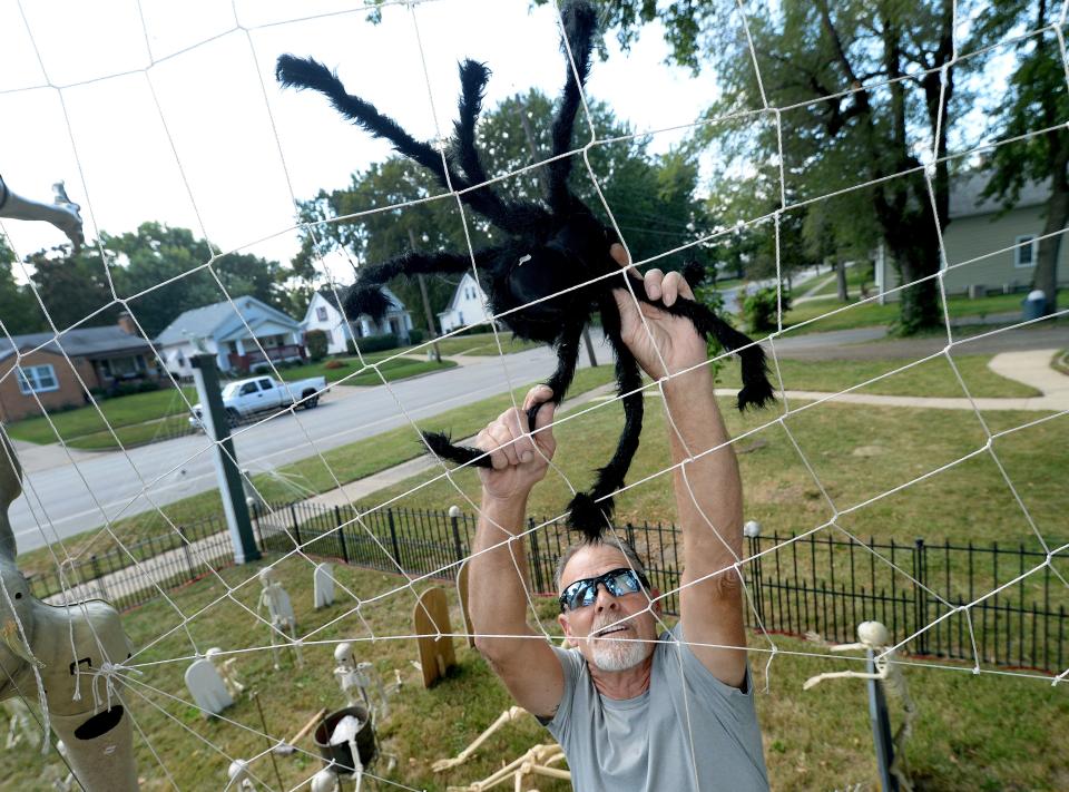 Ed Stark works on Halloween decorations in his yard on Eastman Avenue in Springfield on Tuesday, Sept. 12, 2023.