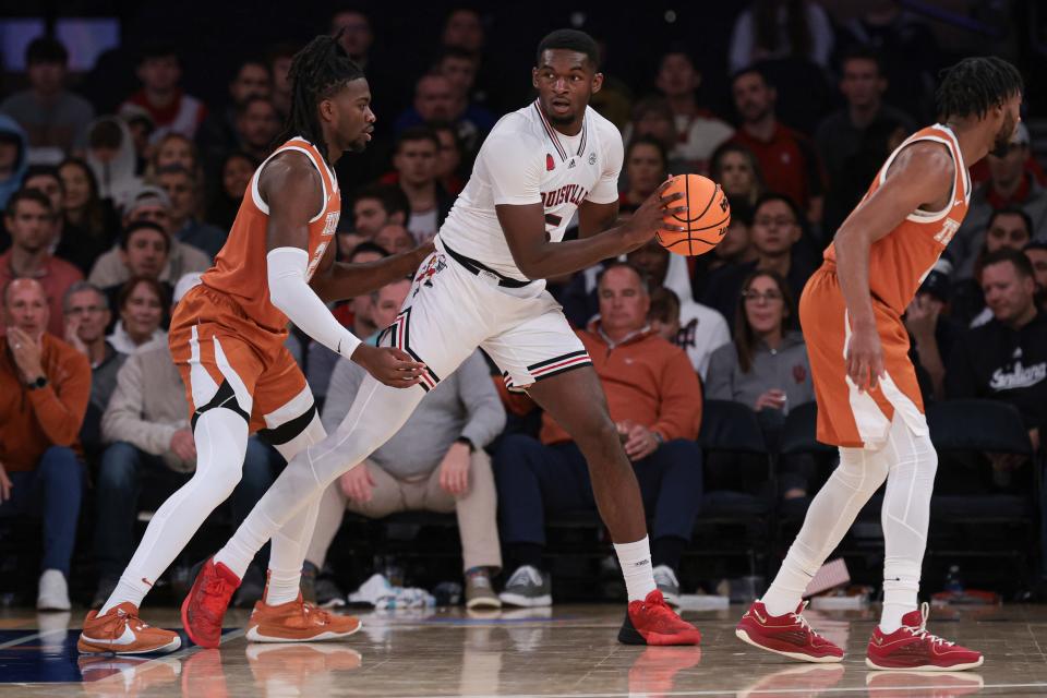 Nov 19, 2023; New York, New York, USA; Louisville Cardinals forward Brandon Huntley-Hatfield (5) is guarded by Texas Longhorns forward Ze'Rik Onyema (21) during the first half at Madison Square Garden. Mandatory Credit: Vincent Carchietta-USA TODAY Sports