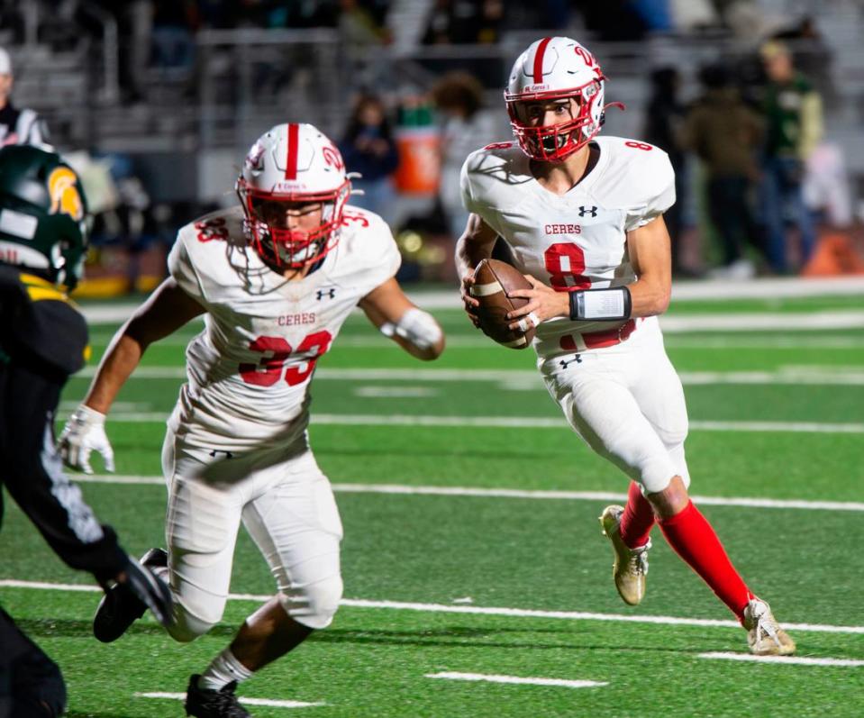 Donovan Osuna, 8, of Ceres High gets protection from teammate Isaac Vizcarra, 33, as he looks up field for an open man during a WAC game against Davis High on Friday Oct. 27, 2023.