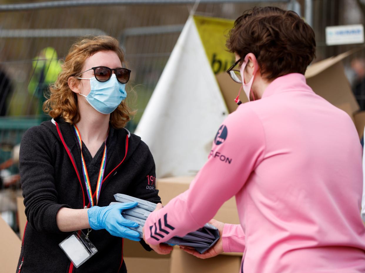 Staff hand out home testing kits for the coronavirus disease (COVID-19) to local residents on Clapham Common in London (REUTERS)