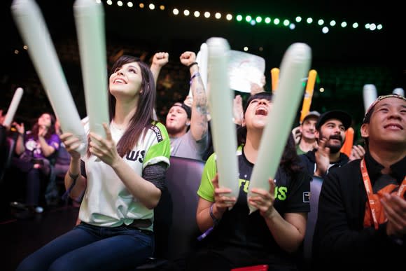 Fans cheering at an Overwatch League competitive match.