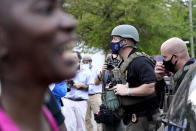 People gather outside the municipal building after at least one Pasquotank County Sheriff's deputy shot and killed a Black man, Andrew Brown Jr., while executing a search warrant, the sheriff's office said, Wednesday, April 21, 2021, in Elizabeth City, N.C. The deputy was wearing an active body camera at the time of the shooting, said Sheriff Tommy Wooten II, who declined to say how many shots the deputy fired or release any other details, citing a pending review by the State Bureau of Investigation. (AP Photo/Gerry Broome)