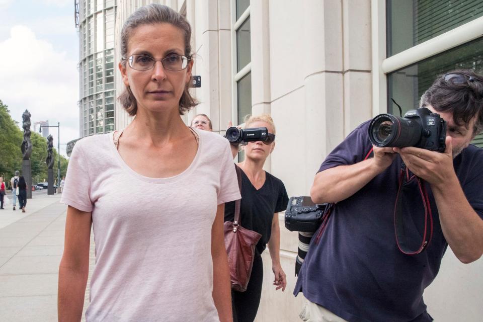 Clare Bronfman, left, leaves federal court, Tuesday, July 24, 2018, in the Brooklyn borough of New York. Bronfman, an heiress to the Seagram's liquor fortune and three other people were arrested on Tuesday in connection with the investigation of a self-improvement organization accused of branding some of its female followers and forcing them into unwanted sex.