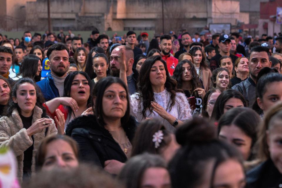 People attend a celebration in a public square in the predominantly Christian town of Qaraqosh ahead of the Pope’s visit to the townAFP via Getty Images