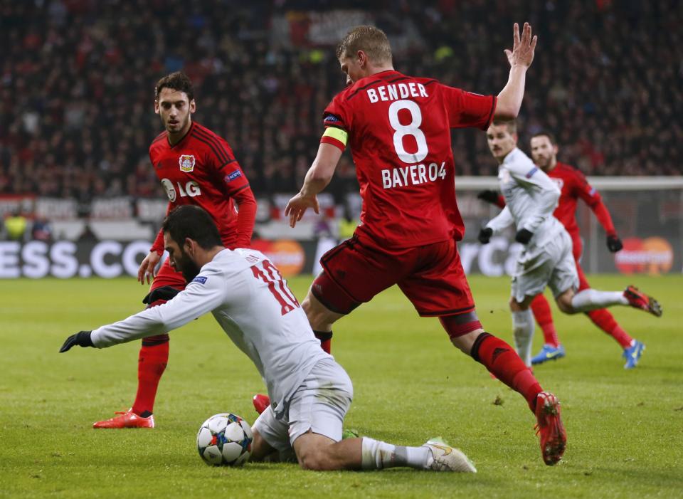 Bayer Leverkusen's Bender challenges Atletico Madrid's Turan during Champions League soccer match in Leverkusen