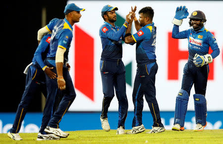 Cricket - Only T20 Match - Sri Lanka v India - Colombo, Sri Lanka - September 6, 2017 - Sri Lanka's Seekkuge Prasanna celebrates with captain Upul Tharanga and his teammates after taking the wicket of India's Lokesh Rahul (not pictured). REUTERS/Dinuka Liyanawatte