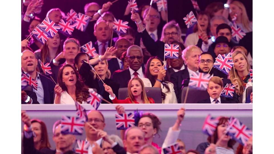 Kate, Charlotte and George waving flags at jubilee concert