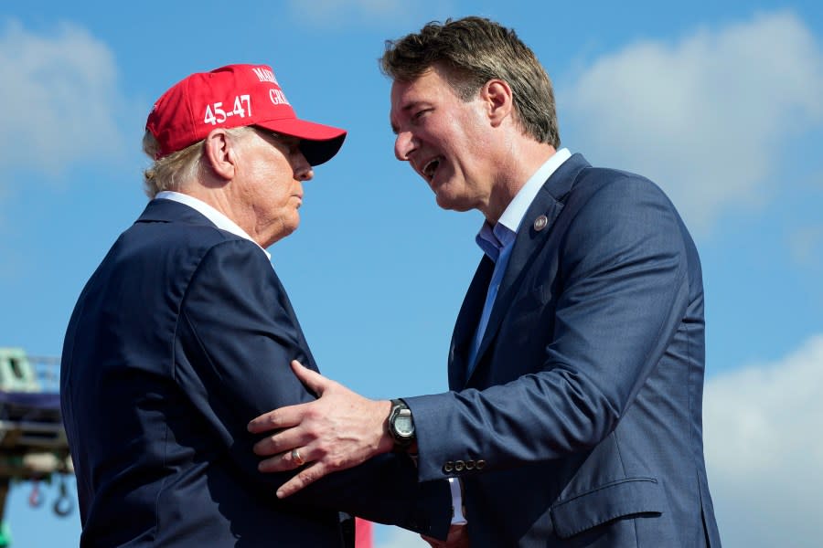 Republican presidential candidate former President Donald Trump left, greets Virginia Gov. Glenn Youngkin, at a campaign rally in Chesapeake, Va., Friday June 28, 2024. (AP Photo/Steve Helber)