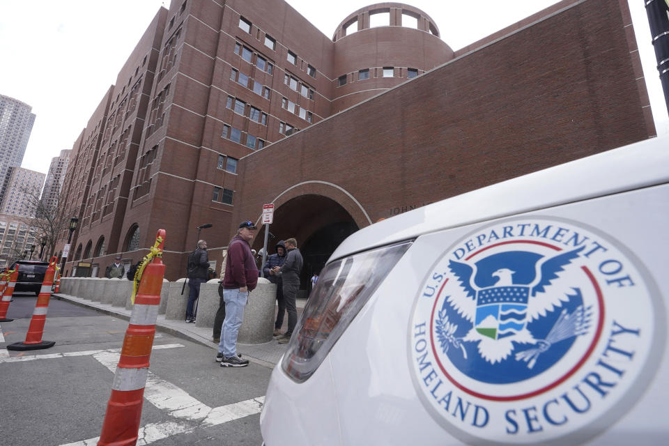 FILE - A Homeland Security vehicle, right, is parked outside the Moakley Federal Courthouse, April 19, 2023, in Boston. A citizen of China who is a student at the Berklee College of Music was convicted Thursday, Jan. 25, 2024, of threatening a person who posted a flyer in support of democracy in China, authorities said. (AP Photo/Steven Senne, File)