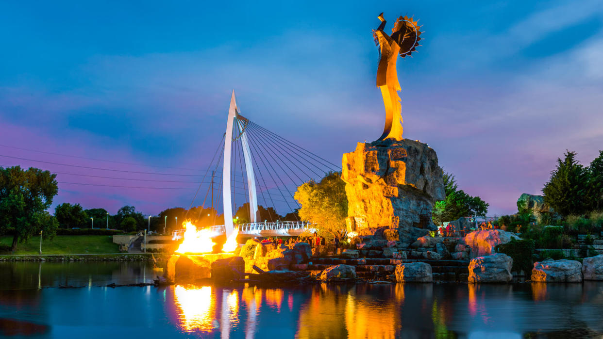 Lighting of the flames at the Keeper of the Plains steel sculpture on the Arkansas River.