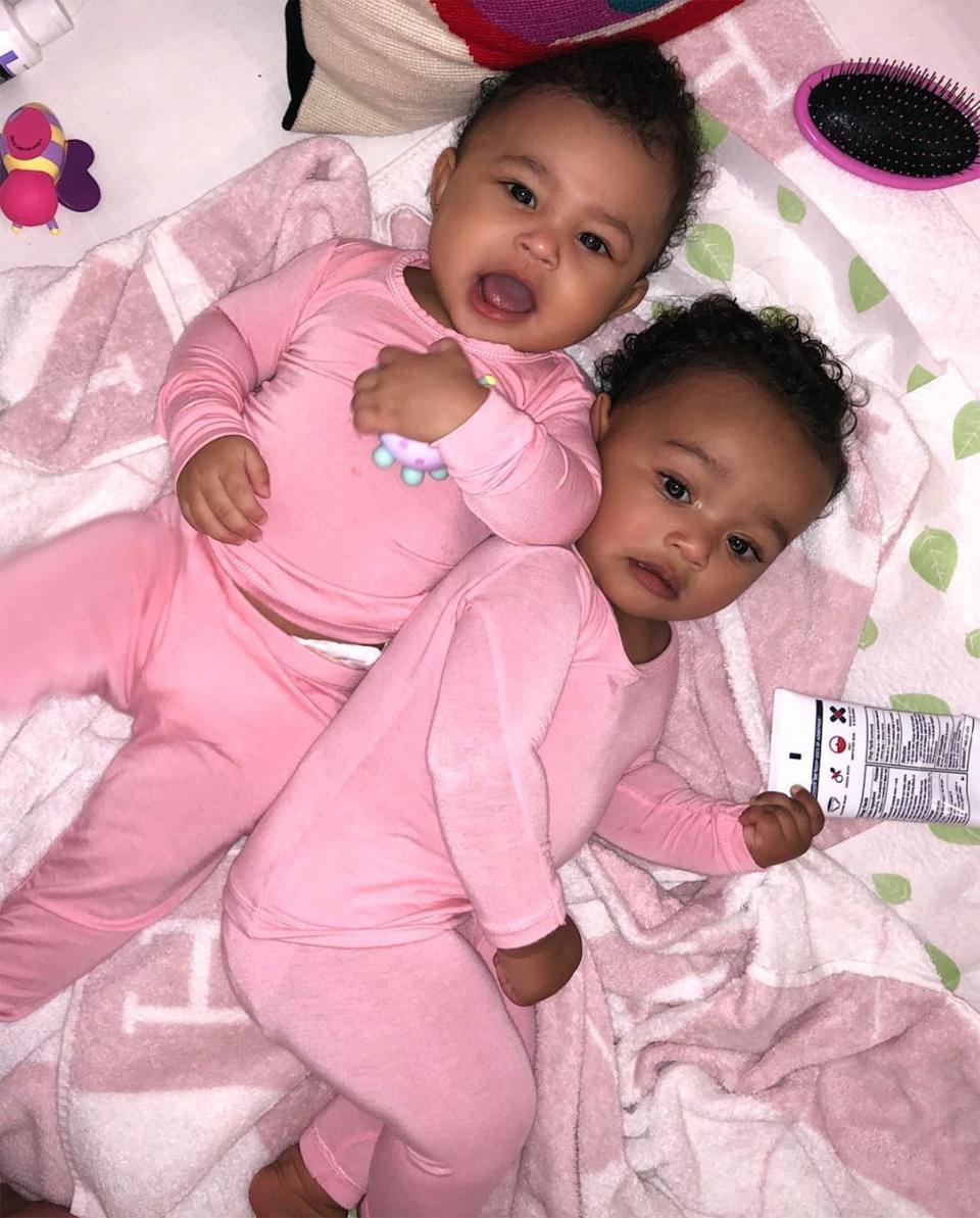 Rise and shine! Stormi snuggled with her cousin, Chicago, in matching pink pajamas. 
