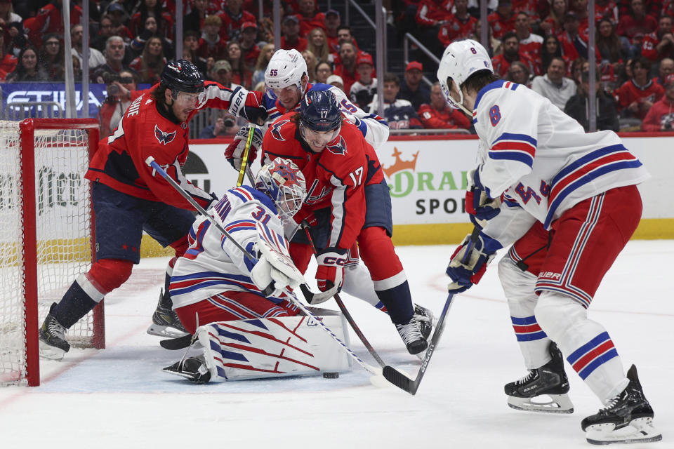 New York Rangers goaltender Igor Shesterkin (31) makes a save during the first period against the Washington Capitals in Game 3 of an NHL hockey Stanley Cup first-round playoff series, Friday, April 26, 2024, in Washington. (AP Photo/Tom Brenner)