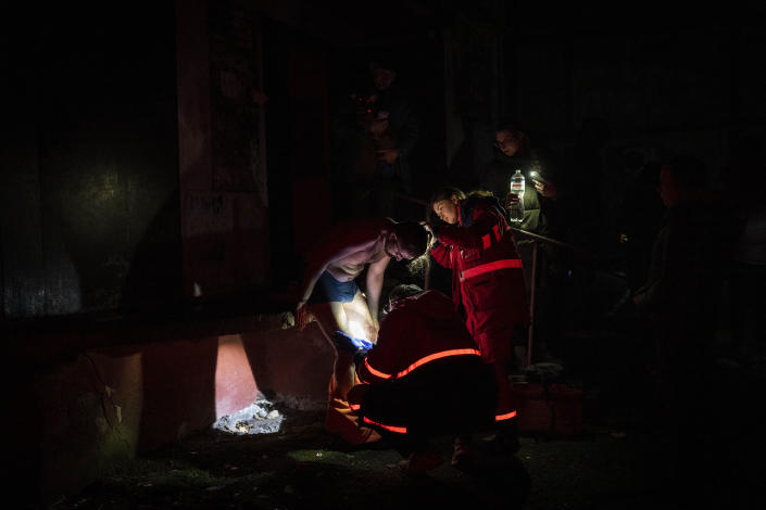 Ukrainian paramedics examine a resident wounded during a Russian strike in Kherson, southern Ukraine, Thursday, Nov. 24, 2022. (AP Photo/Bernat Armangue)