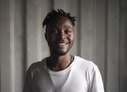 Maro Reele, 22, from Guinea poses for a portrait aboard the humanitarian rescue ship Ocean Viking, in Italian waters off the Sicilian town of Messina, southern Italy, Monday, Sept. 23, 2019, hours before disembarking. Reele traveled alone but often helped the mothers on board, taking care of the little children, playing with them and even carrying them while they took a nap on his shoulders. (AP Photo/Renata Brito)