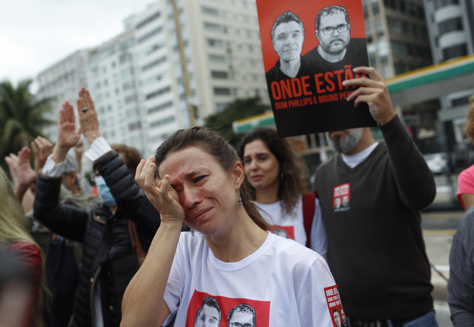 A woman cries during a demonstration to protest the disappearance, in the Amazon, of British journalist Dom Phillips and expert on indigenous affairs Bruno Araujo Pereira, in Copacabana beach, Rio de Janeiro, Brazil, Sunday, June 12, 2022. Federal Police and military forces are carrying out searches and investigations into the disappearance of Phillips and Pereira in the Javari Valley Indigenous territory, a remote area of the Amazon rainforest in Atalaia do Norte, Amazonas state. (AP Photo/Bruna Prado)