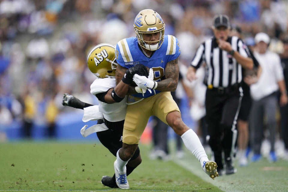 Alabama State defensive back Jeffrey Scott Jr. (7) tackles UCLA wide receiver Kazmeir Allen (19) during the first half of an NCAA college football game in Pasadena, Calif., Saturday, Sept. 10, 2022. (AP Photo/Ashley Landis)