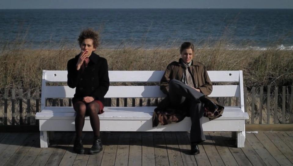 Greta Gerwig and Olly Alexander sit on a bench on the Boardwalk in Rehoboth Beach in the 2011 film "The Dish & the Spoon."