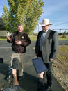 CORRECTS TO SAY WHAT AUTHORITIES THOUGHT WERE THE REMNANTS OF AN EXPLOSIVE DEVICE TURNED OUT TO BE NONEXPLOSIVE MATERIALS - Lewis and Clark County Undersheriff Jason Grimmis, left, and Sheriff Leo Dutton, right, update reporters on what they thought was a homemade bomb that detonated in an elementary school playground on Tuesday, Oct. 15, 2019, in Helena, Mont. Authorities evacuated the elementary school in Montana's capital city Tuesday after officials found what they thought were the remnants of a homemade bomb, but they turned out to be a plastic bottle filled with nuts and bolts left in the schoolyard. (AP Photo/Amy Beth Hanson)