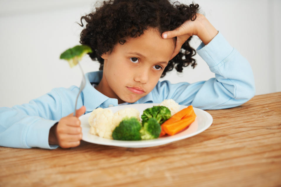 Shot of an unimpressed-looking little boy sitting in front of a plate of vegetableshttp://195.154.178.81/DATA/i_collage/pi/shoots/785154.jpg