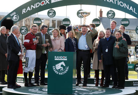 Horse Racing - Grand National Festival - Aintree Racecourse, Liverpool, Britain - April 14, 2018 Ryanair Chief Executive and owner of Tiger Roll Michael O'Leary (C), trainer Gordon Elliott (2nd R) and Davy Russell (L) celebrate with their trophies after the 17:15 Randox Health Grand National Handicap Chase Action Images via Reuters/Matthew Childs