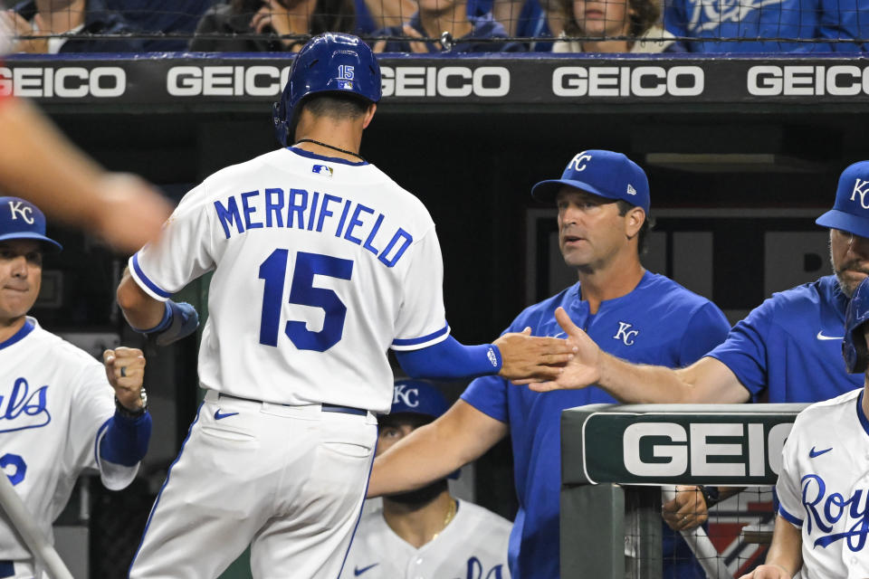 Kansas City Royals' Whit Merrifield (15) is congratulated by manager Mike Matheny, second from right, after scoring against the Los Angeles Angels during the seventh inning of a baseball game, Monday, July 25, 2022, in Kansas City, Mo. (AP Photo/Reed Hoffmann)