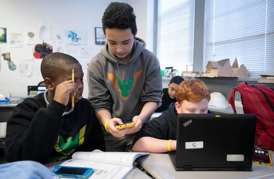 Ninth-grader Leo Davis-Ding, center, works with sixth graders Matthew Solomon, left and Benjamin Zeren during an after-school math tutoring program on Thursday, January 30, 2020 at Wake Young Men’s Leadership Academy in Raleigh, N.C.