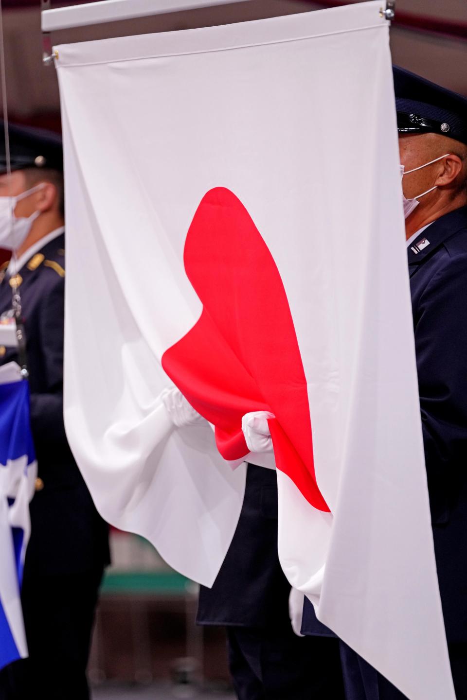 The flag of Japan is raised for the women's judo +68 medal ceremony at Nippon Budokan.