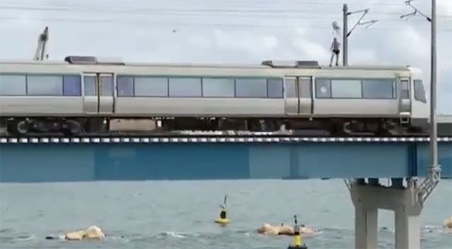 The person stands on the carriage as it crosses the Swan River in Fremantle. Source: Facebook/ Brown Cardigan