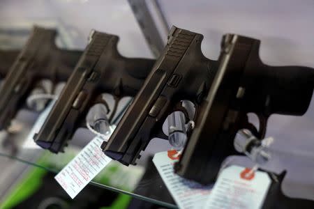 Handguns are seen for sale in a display case at Metro Shooting Supplies in Bridgeton, Missouri, November 13, 2014. REUTERS/Jim Young