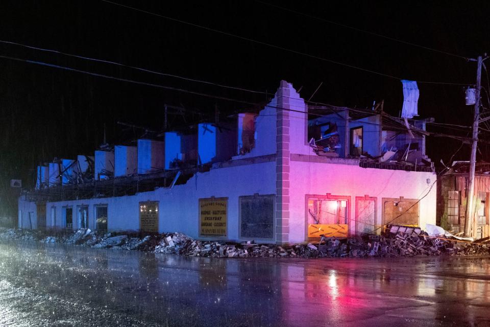 Emergency vehicle lights illuminate a building damaged due to a possible tornado touching down in Sunbright, Tennessee, U.S., April 2, 2024 (via REUTERS)